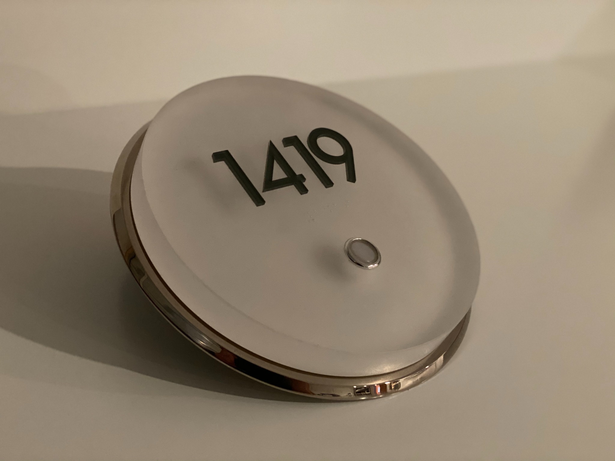 Round room 1419 sign with polished metal edge